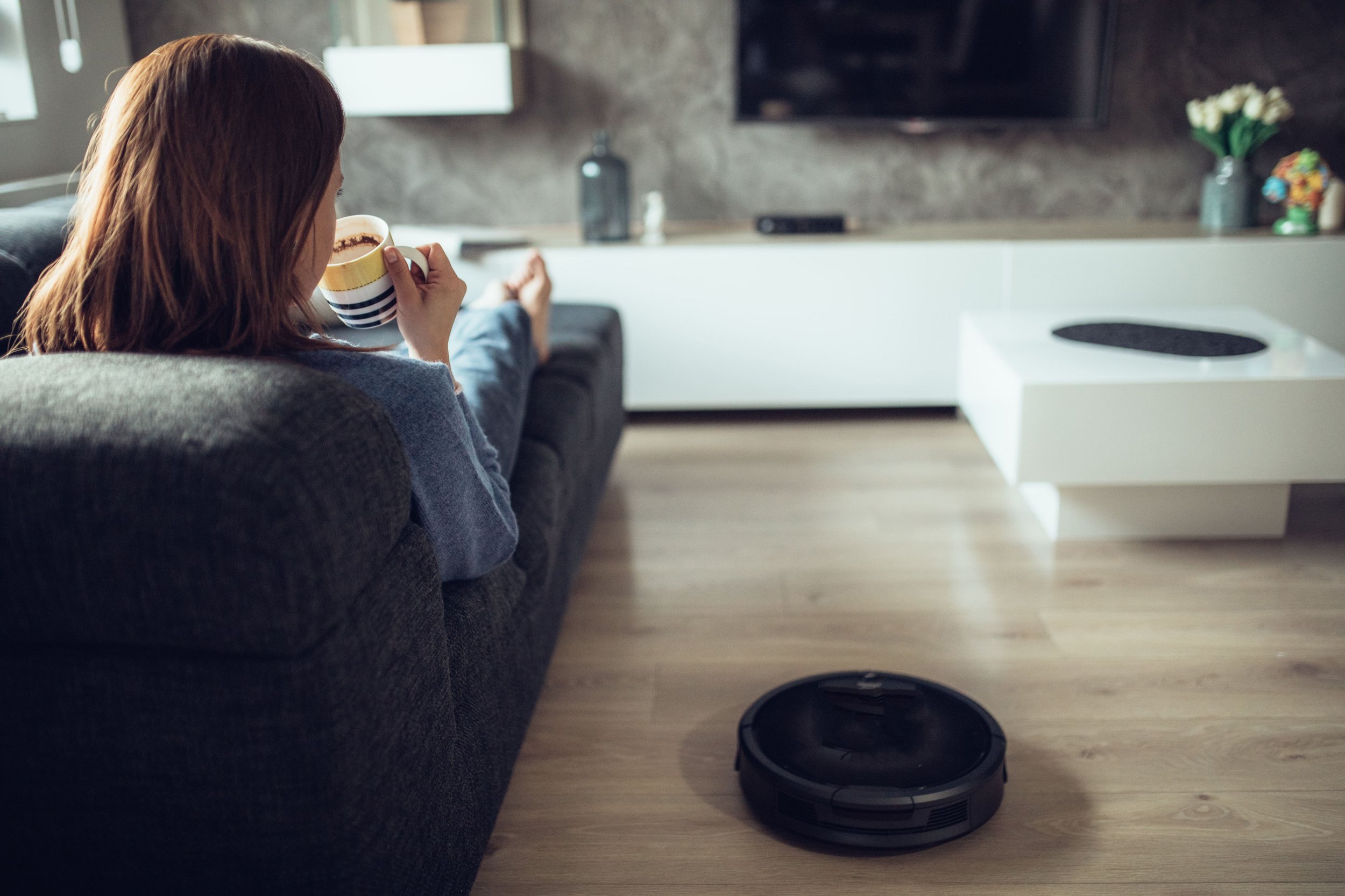 Relaxing next to automatic vacuum cleaner